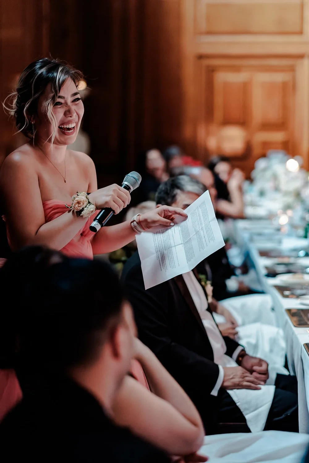 A bridesmaid delivering her speech with her notes in hand