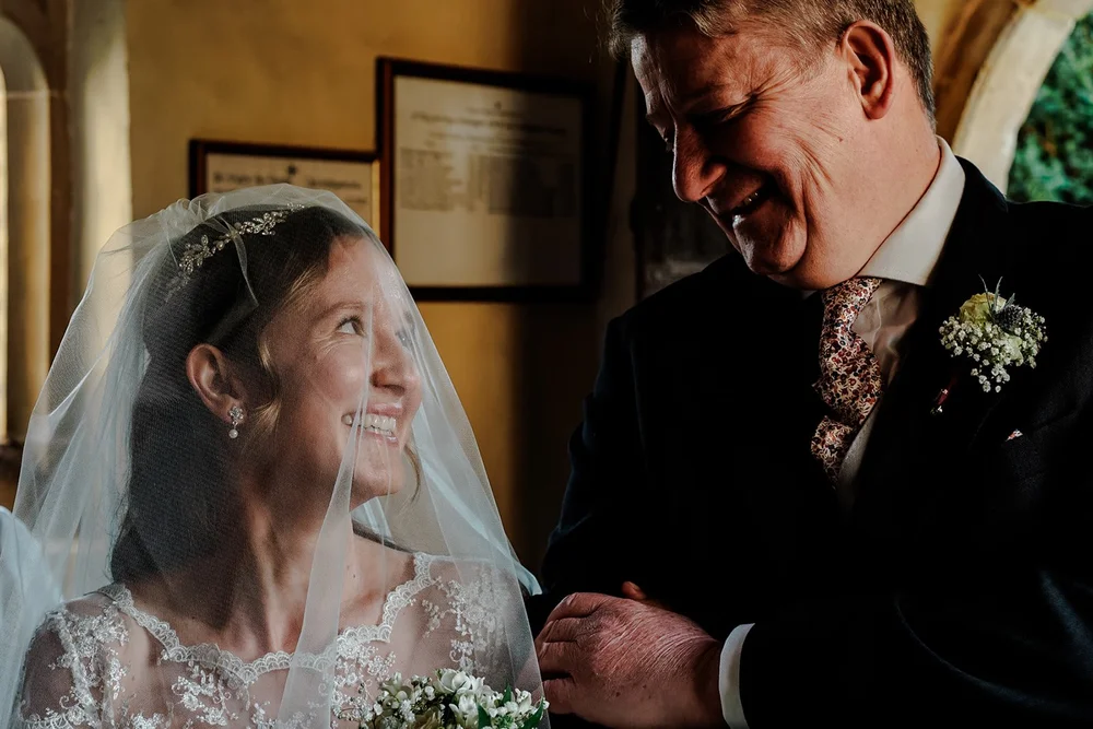Bride looking up at her groom through her veil