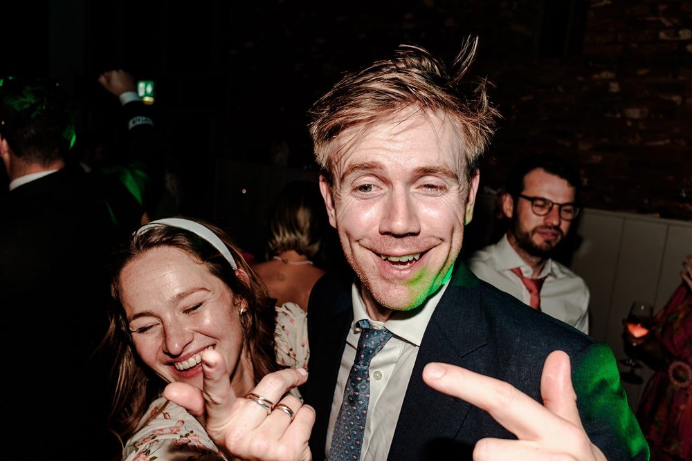 Guests pulling faces and laughing on the dance floor