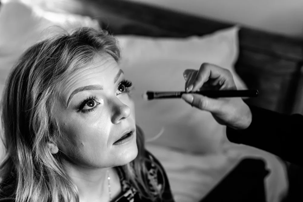 Bride looking up as her make up is finished
