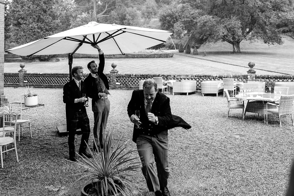 Guests dancing on the lawn under a garden umbrella