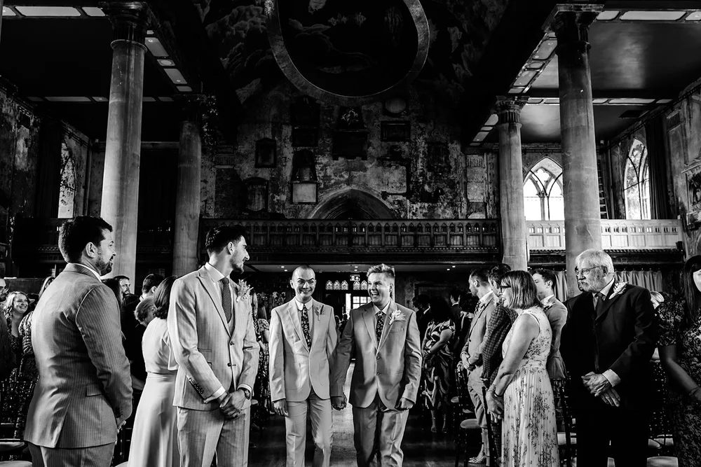 Groom and his groomsmen waiting in a grand church