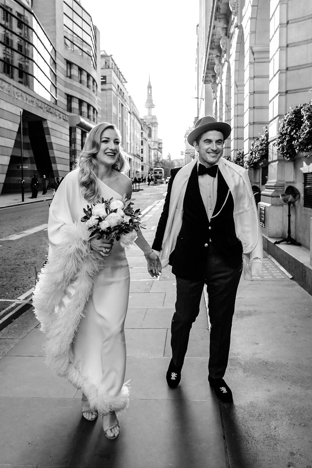 Bride and groom walking through the empty streets of the City of London
