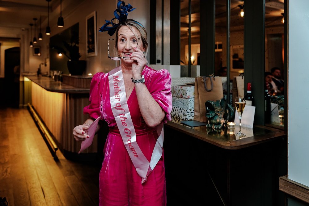 A guest in bright pink celebrating at the bar
