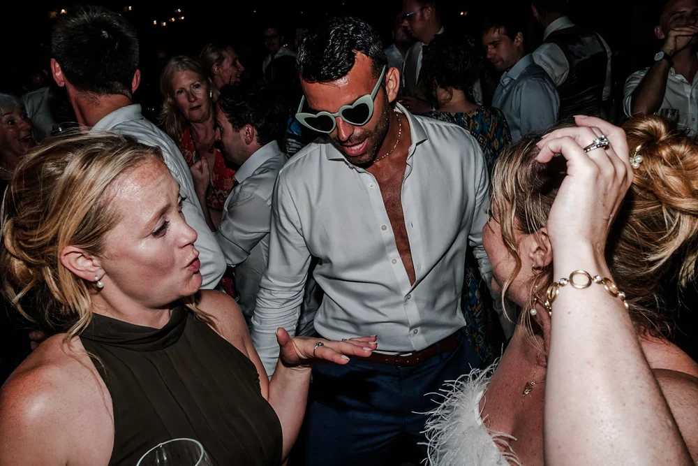 Guests dancing closely together on a packed dance floor