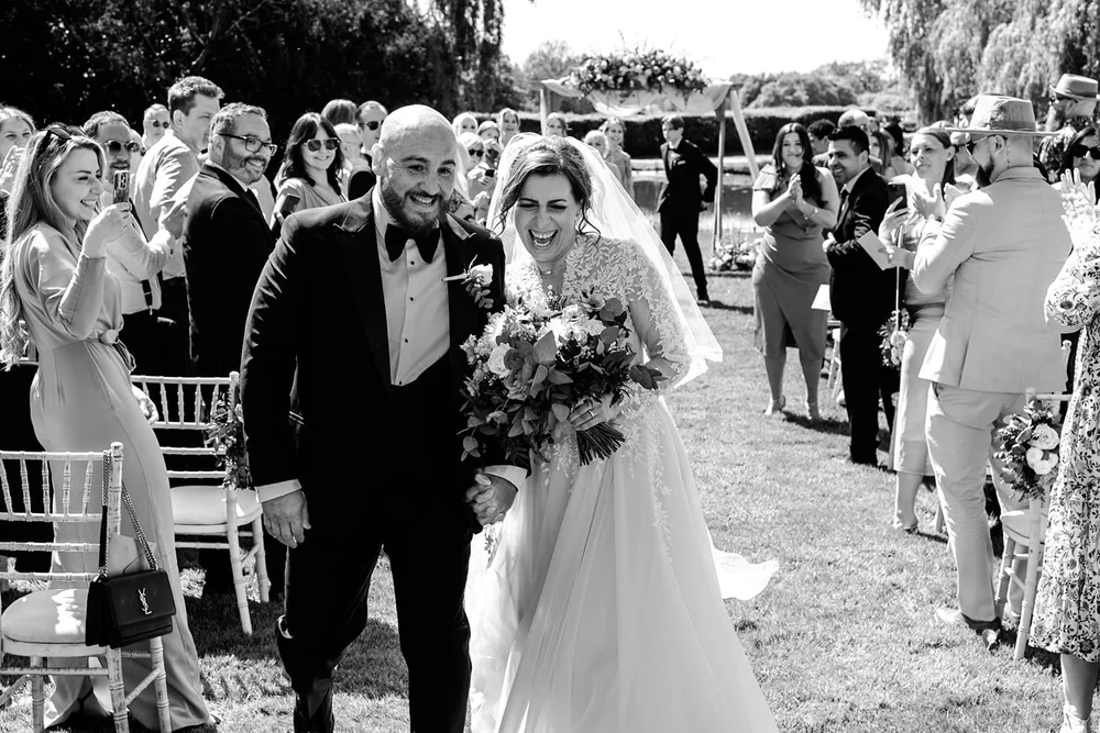Bride and groom walking back down the aisle at an outdoor ceremony