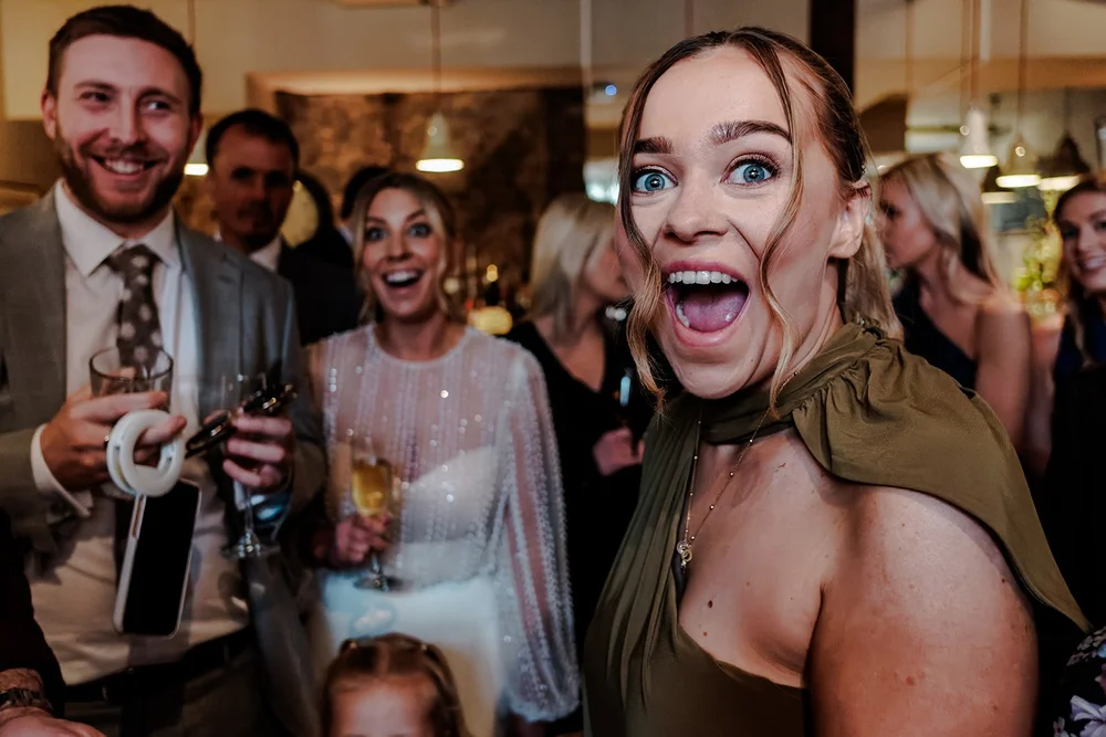 Guests laughing and pulling faces during the drinks reception