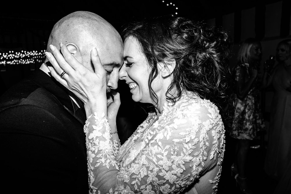 Bride and groom resting their heads together during their first dance