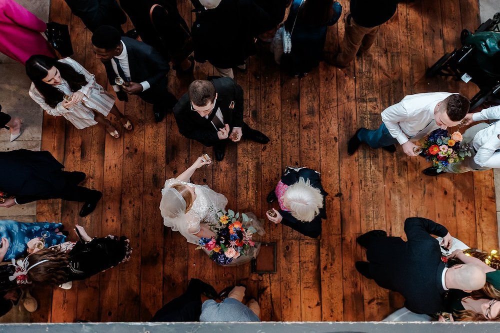 Looking down on the dance floor from above as guests dance on wooden boards