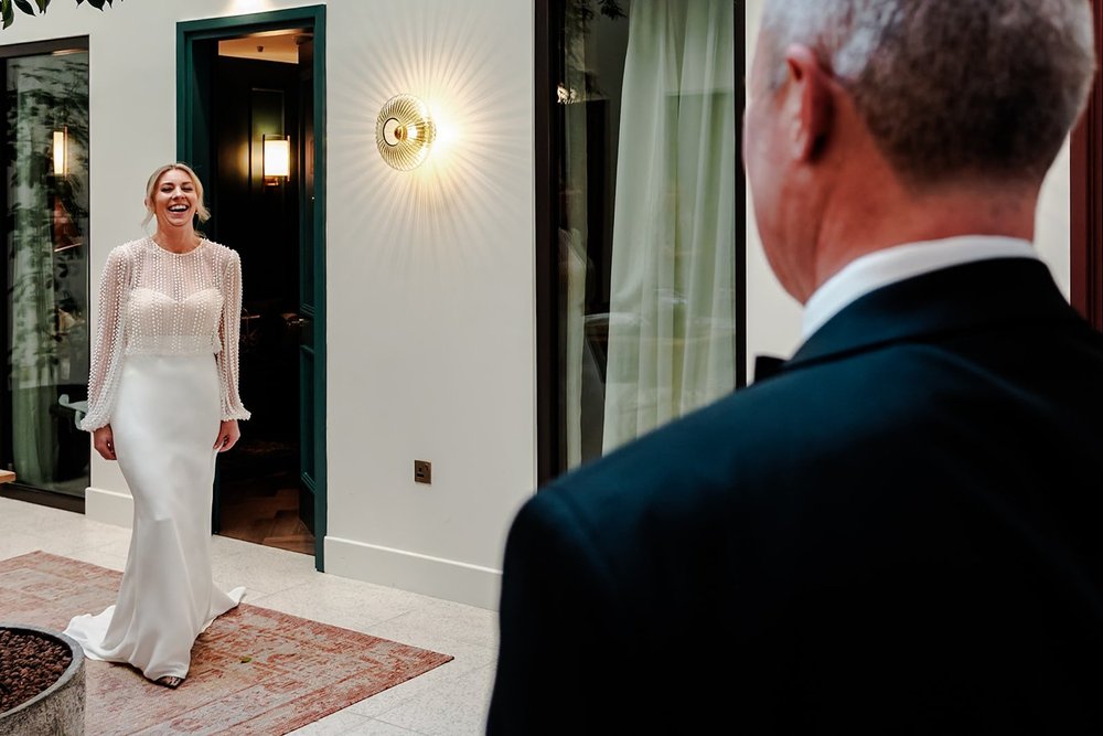 The bride&rsquo;s father seeing her in her dress for the first time