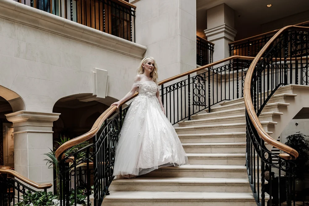 Bride coming down the grand staircase before leaving for the ceremony