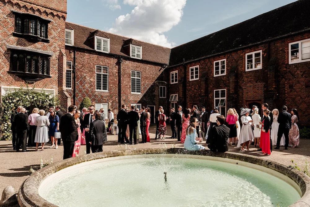 Guests gathered around the fountain in the courtyard at Fulham Palace
