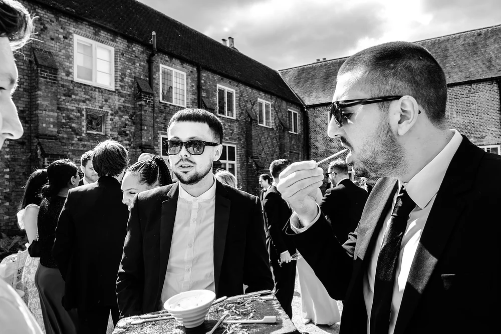 Guests in black tie and sunglasses during the drinks reception