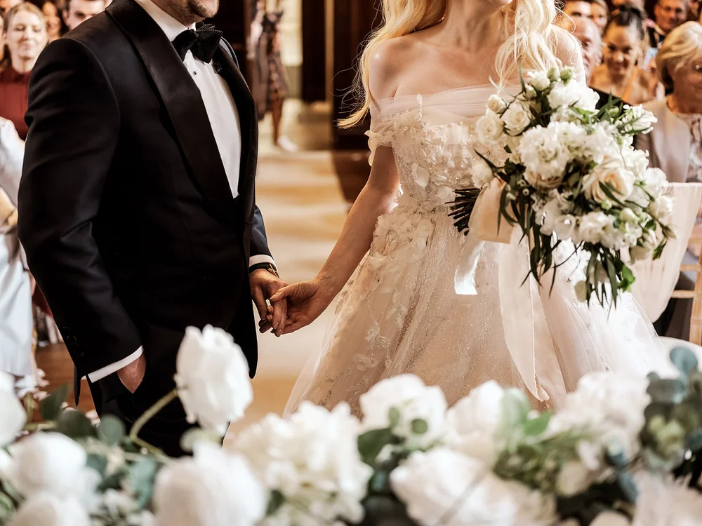 Groom taking the bride&rsquo;s hand at the top of the aisle