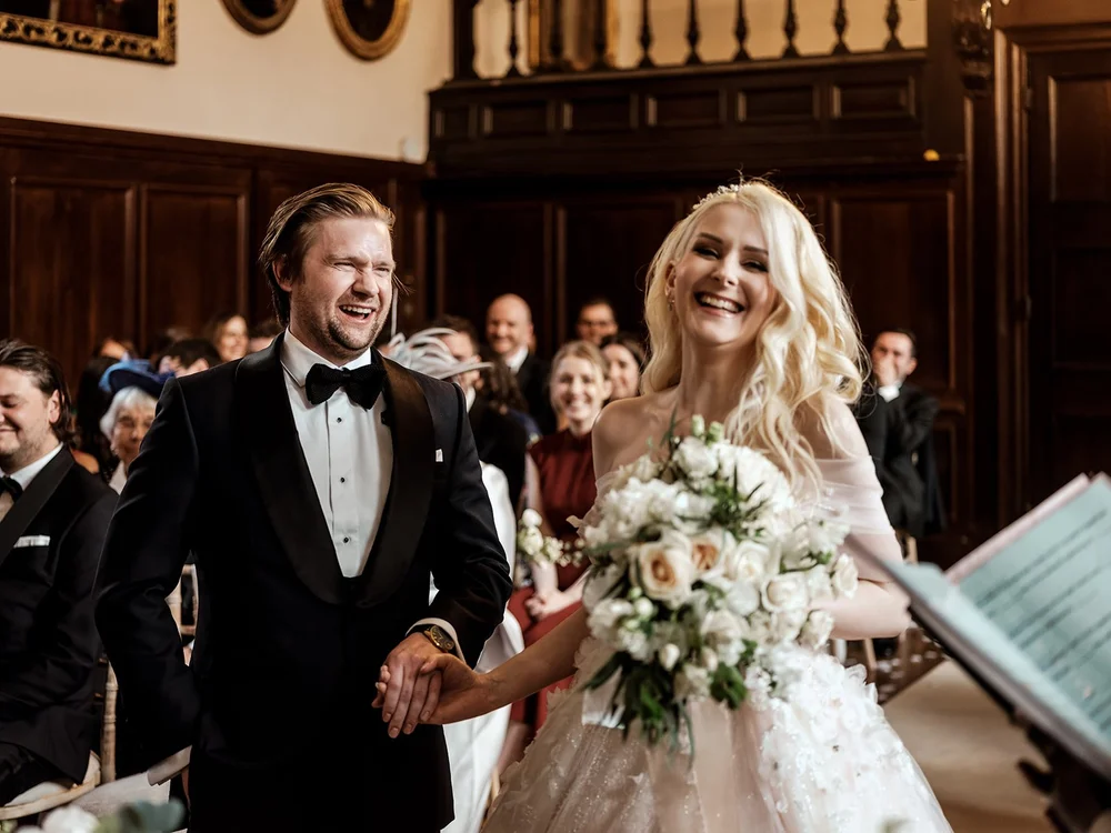Bride and groom laughing as they walk back down the aisle