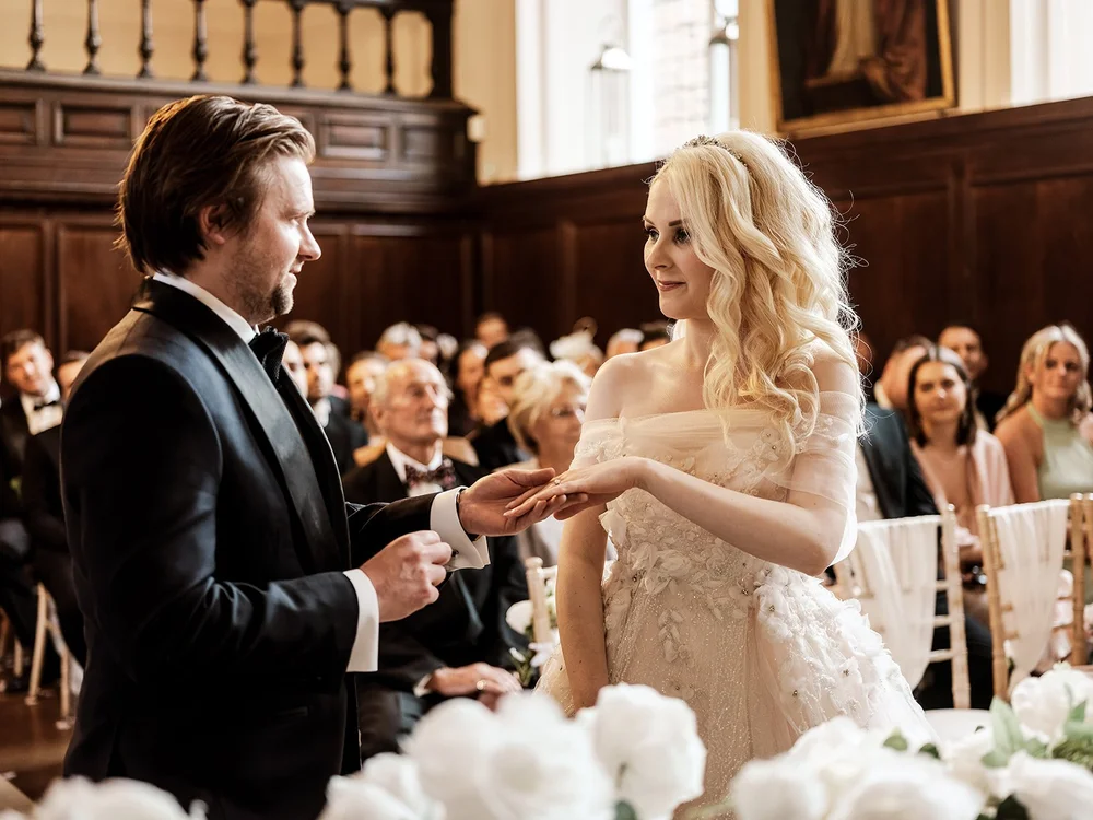 Bride and groom exchanging rings