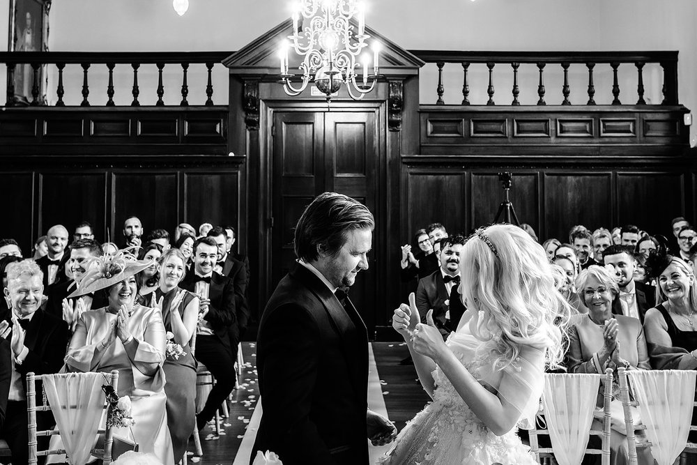The panelled ceremony room and its chandelier during the vows