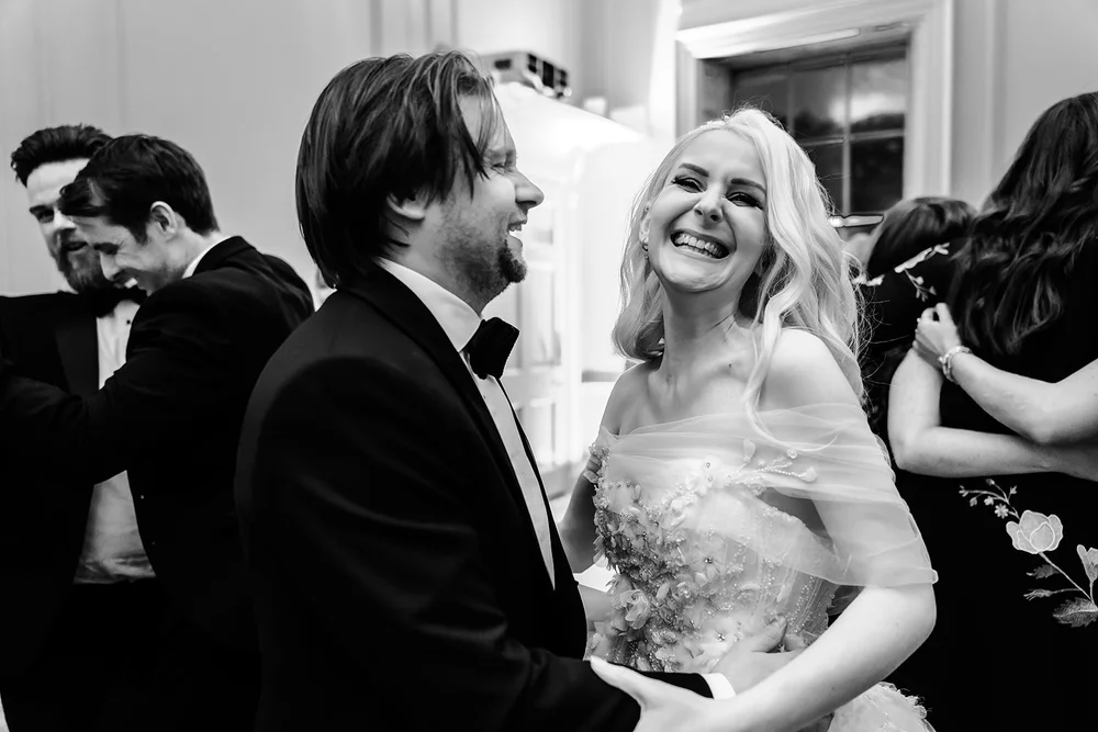 Bride laughing with guests during the evening