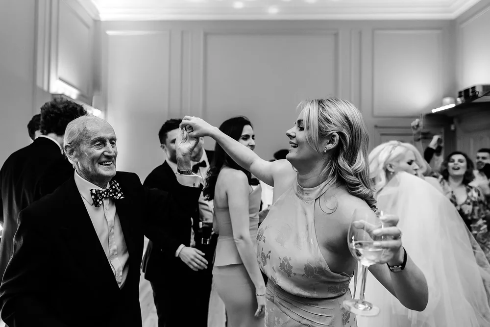 The bride dancing with an older guest