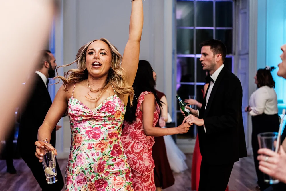 A guest dancing with her arm in the air