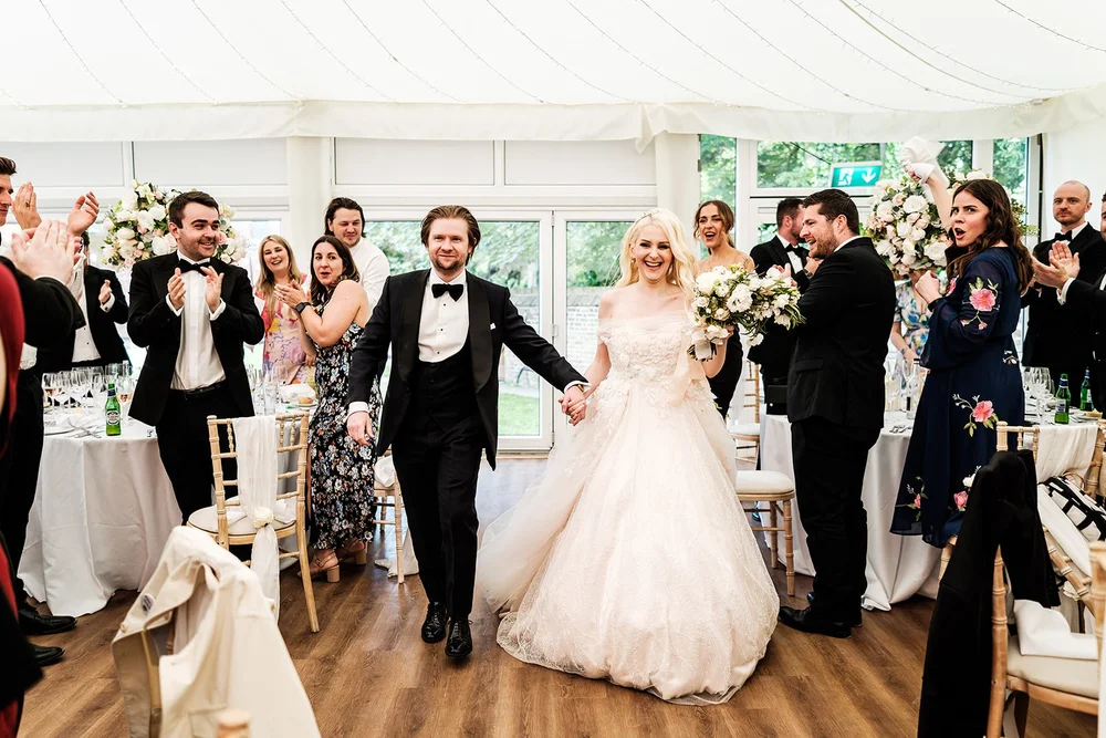 Bride and groom entering the marquee to applause