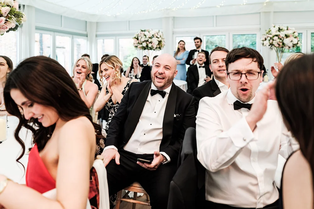 Guests laughing together during the speeches