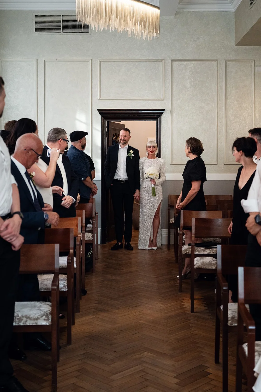 Elisa walking in to her wedding ceremony in the Brydon Room at Chelsea Old Town Hall