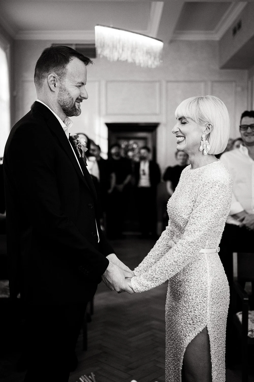 Elisa and Greg exchanging vows in the window light of the Brydon Room at Chelsea Old Town Hall
