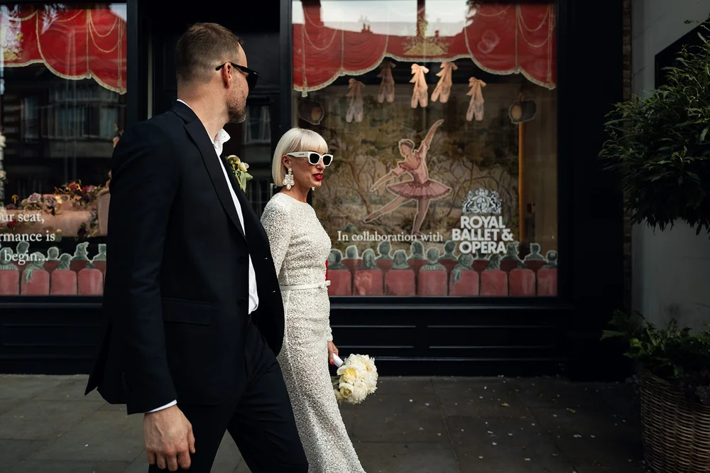 Elisa and Greg photographed against the stucco houses of Chelsea