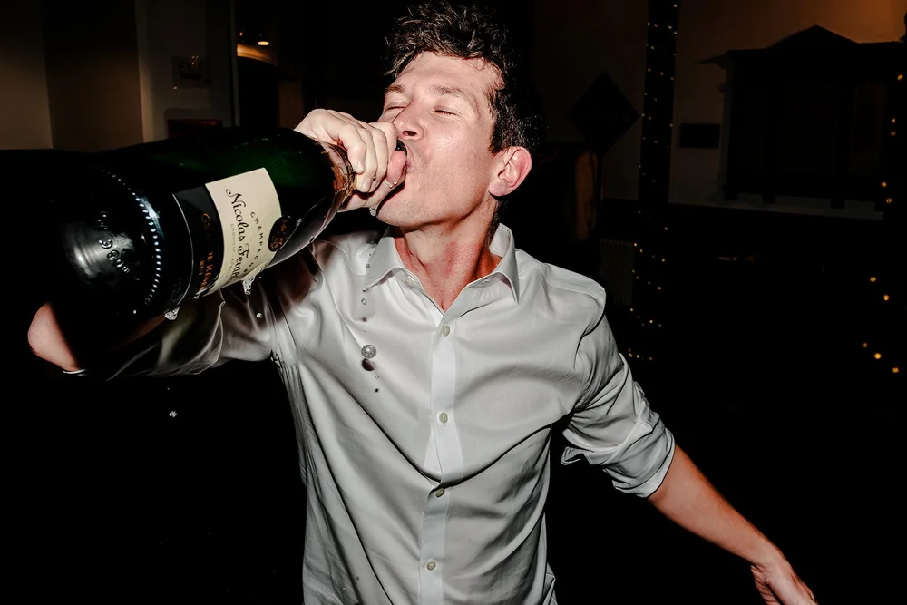 A guest drinking from a magnum of champagne at Fabrica