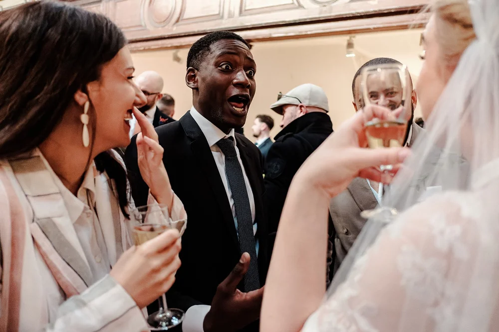 Guests with drinks at the Fabrica Brighton wedding reception