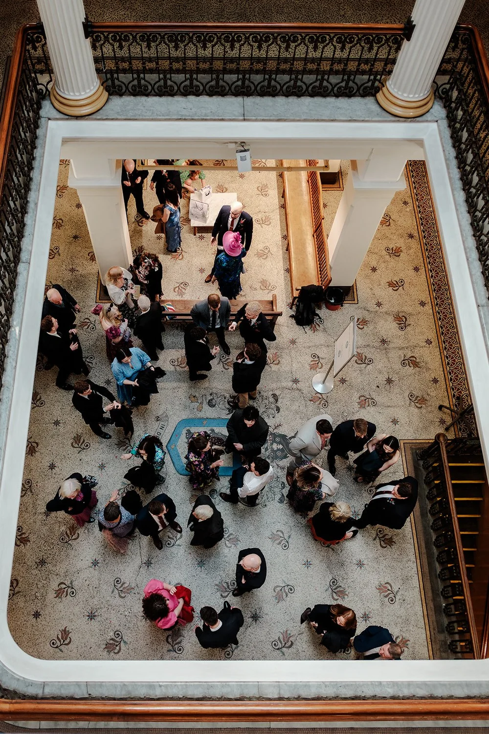 Wedding guests gathered below the grand staircase at Brighton Town Hall