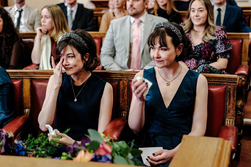 Guests seated on the red benches of the Council Chamber at Brighton Town Hall