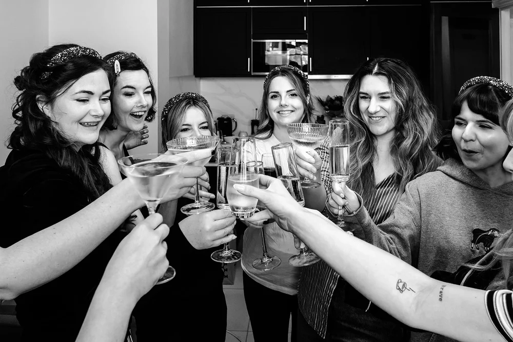 Martinis raised in a circle before a Brighton Town Hall wedding
