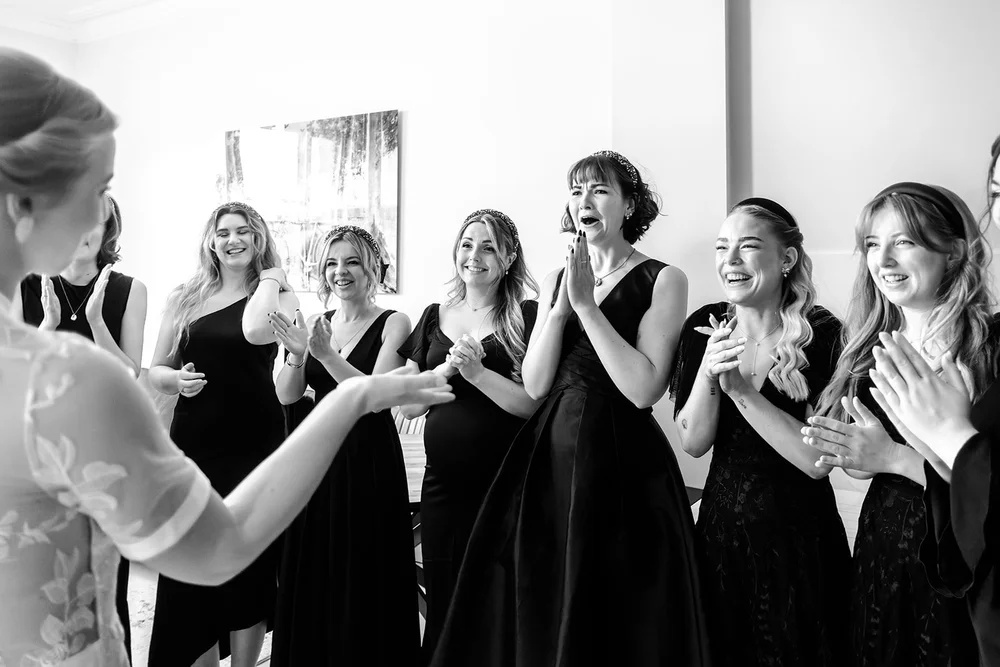 Bridesmaids reacting to seeing Grace in her wedding dress for the first time
