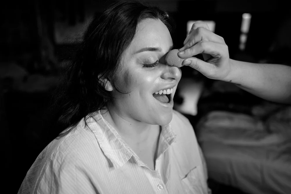 Luisa laughing during hair and make-up before her Liverpool wedding