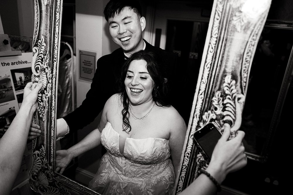 Luisa laughing beside a mirror at Calderstones Mansion House