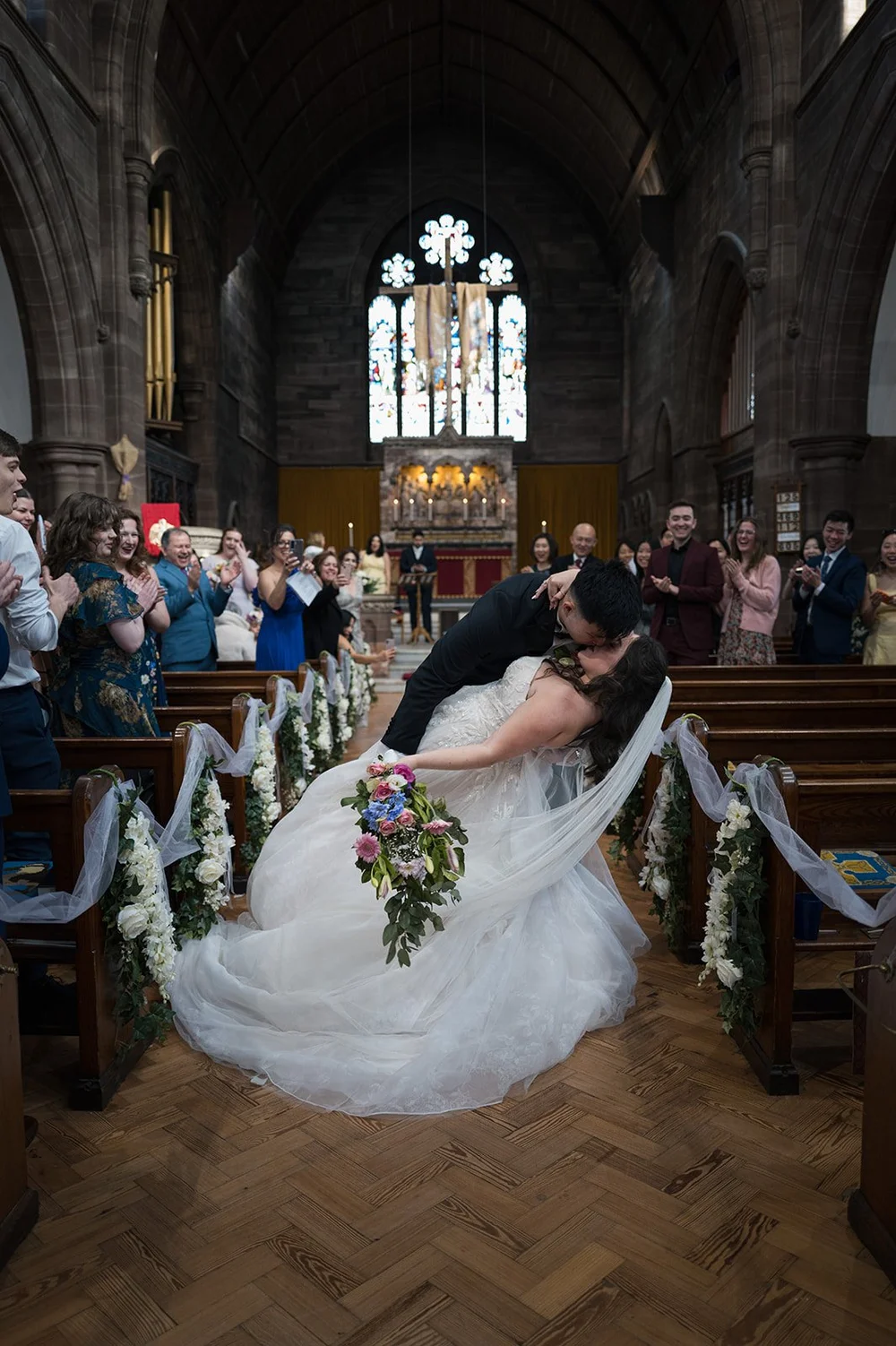 Luisa and Ray walking back down the aisle as husband and wife