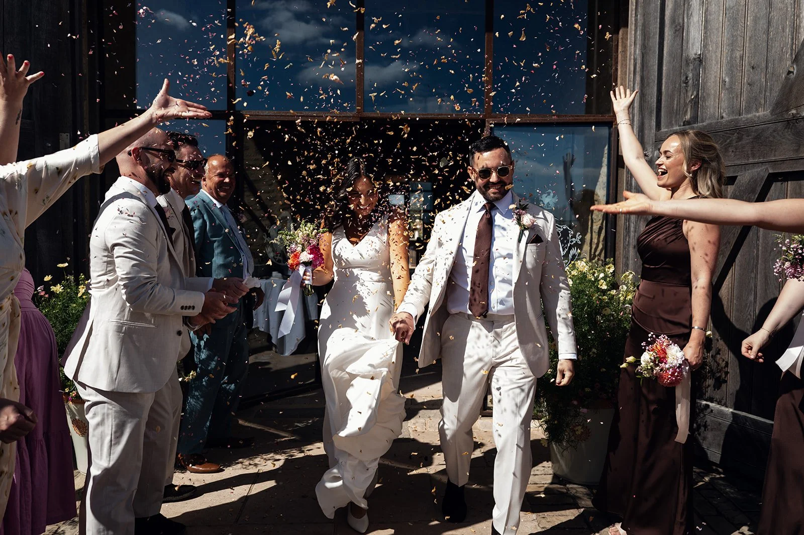 Jimmy and Sophie's confetti exit at their Copsegrove Farm wedding in the Cotswolds