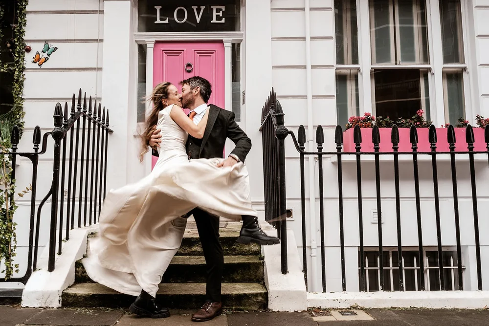 Guests laughing during an outdoor wedding celebration &mdash; natural reportage wedding photography Bristol