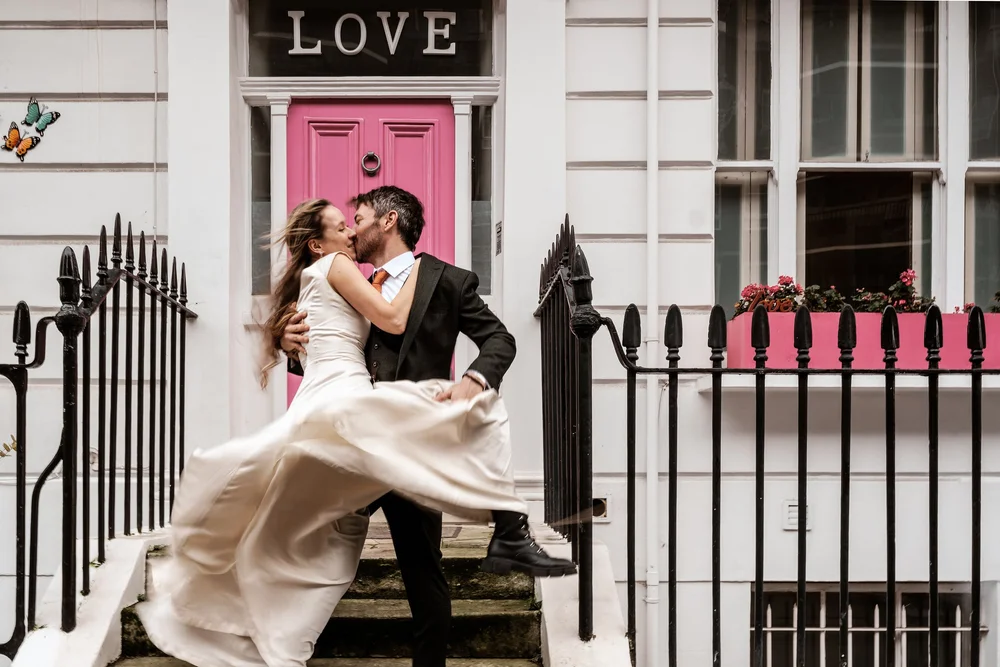 Candid confetti moment outside London wedding venue &mdash; reportage wedding photography by Oliver Holder