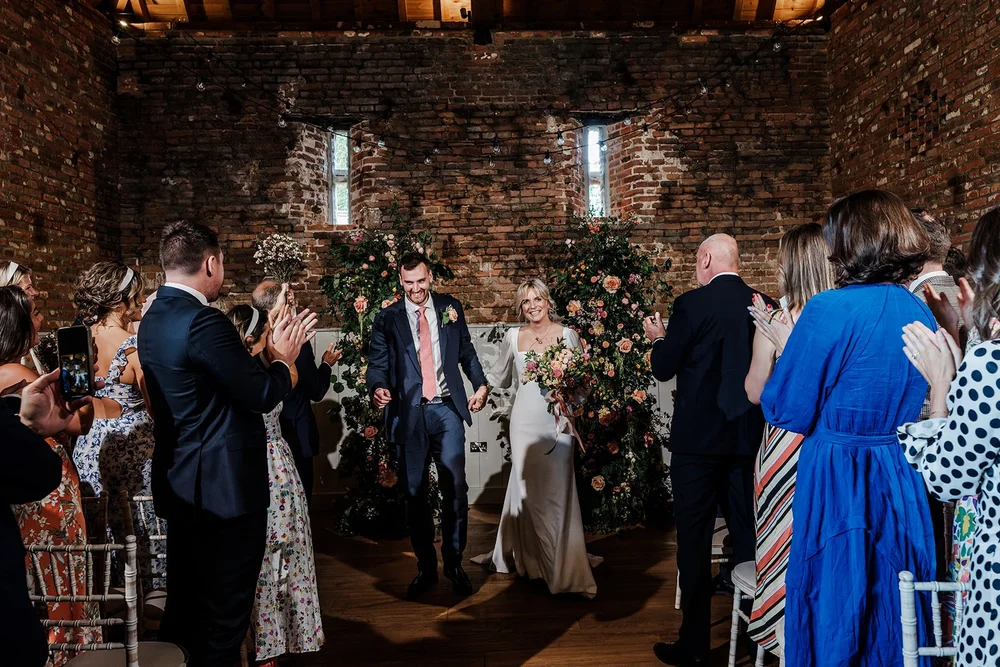 Emotional first dance captured in warm ambient light &mdash; documentary wedding photography London and Bristol