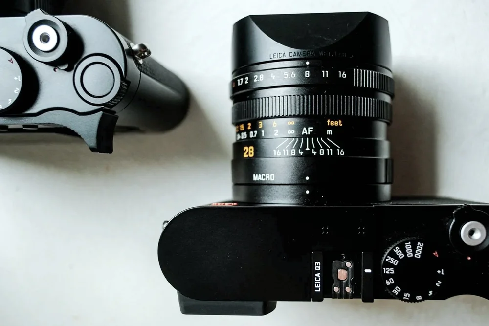 Top down view of the Leica Q3 and Q3 43 showing lens markings and controls