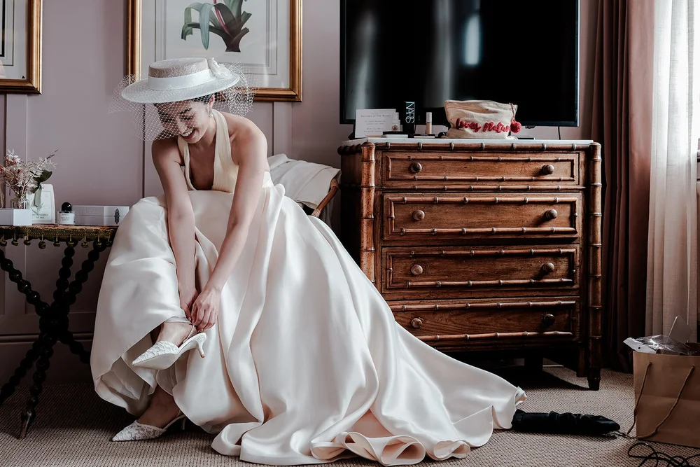 Couple walking hand in hand through golden hour light at their wedding &mdash; romantic natural photography