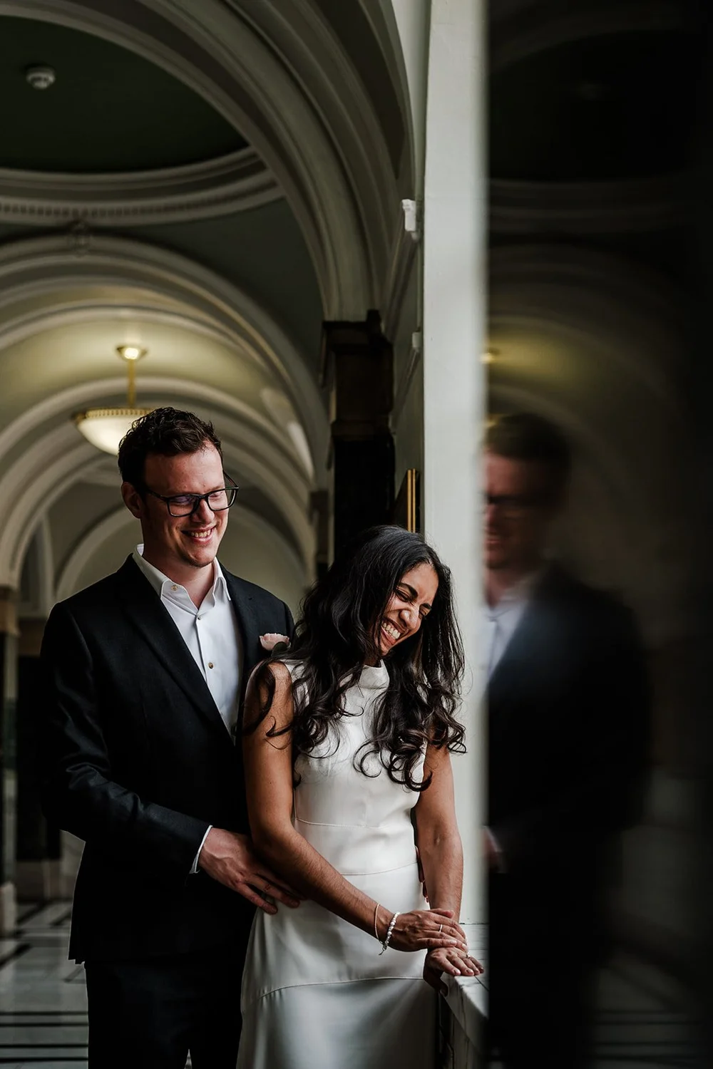 Couple at Islington Town Hall ceremony room during their intimate London wedding &mdash; candid reportage photography by Oliver Holder