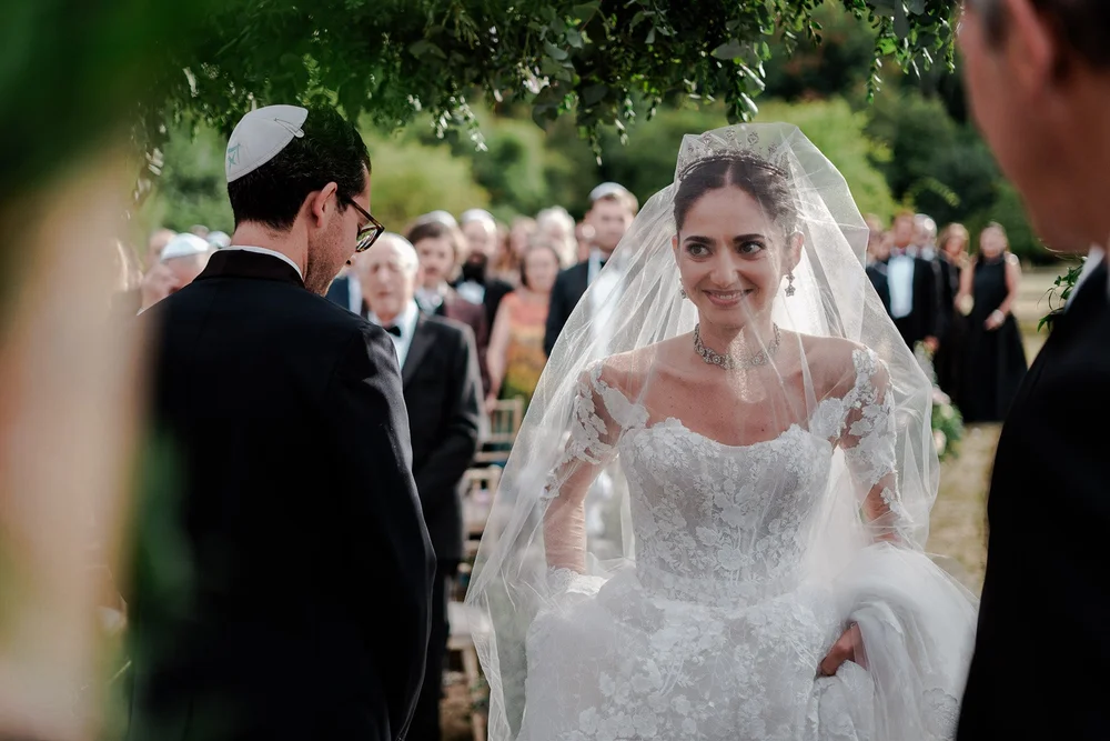 Candid moment of wedding guests cheering during the reception &mdash; atmospheric monochrome celebration photography