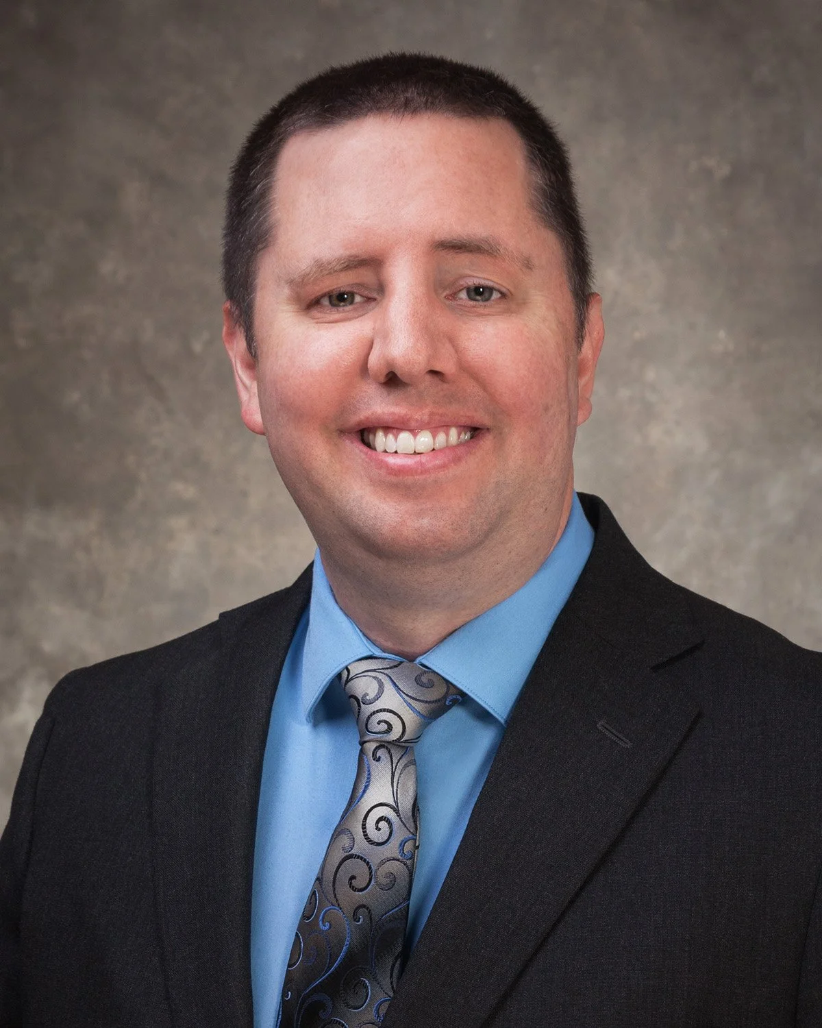Headshot of Eric Ristau in a suit