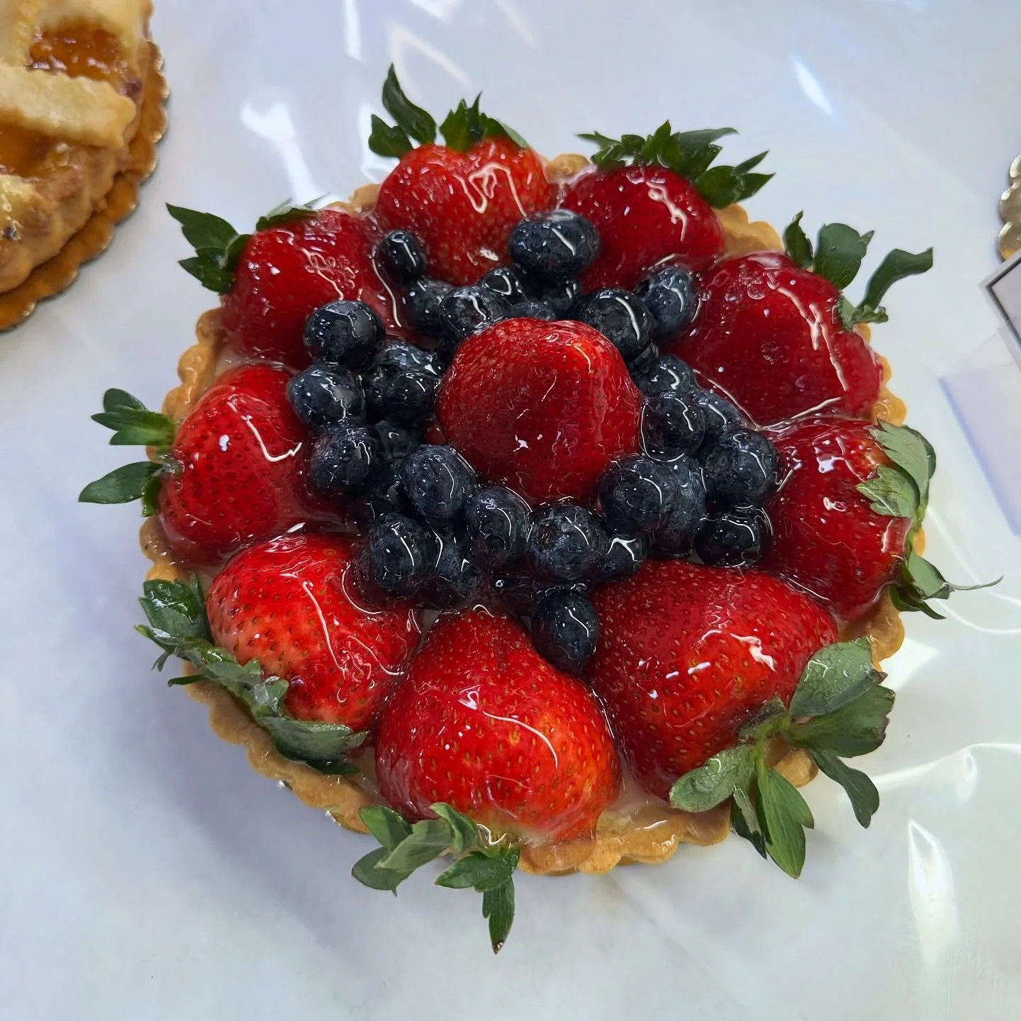 Fresh fruit tart season has entered the chat. 🍓🫐

Our 8 inch fresh fruit tart is layered with a rich custard filling and topped with fresh strawberries 🍓 and blueberries 🫐 in a buttery tart 🥮 shell.

Available Friday through Sunday or made to or