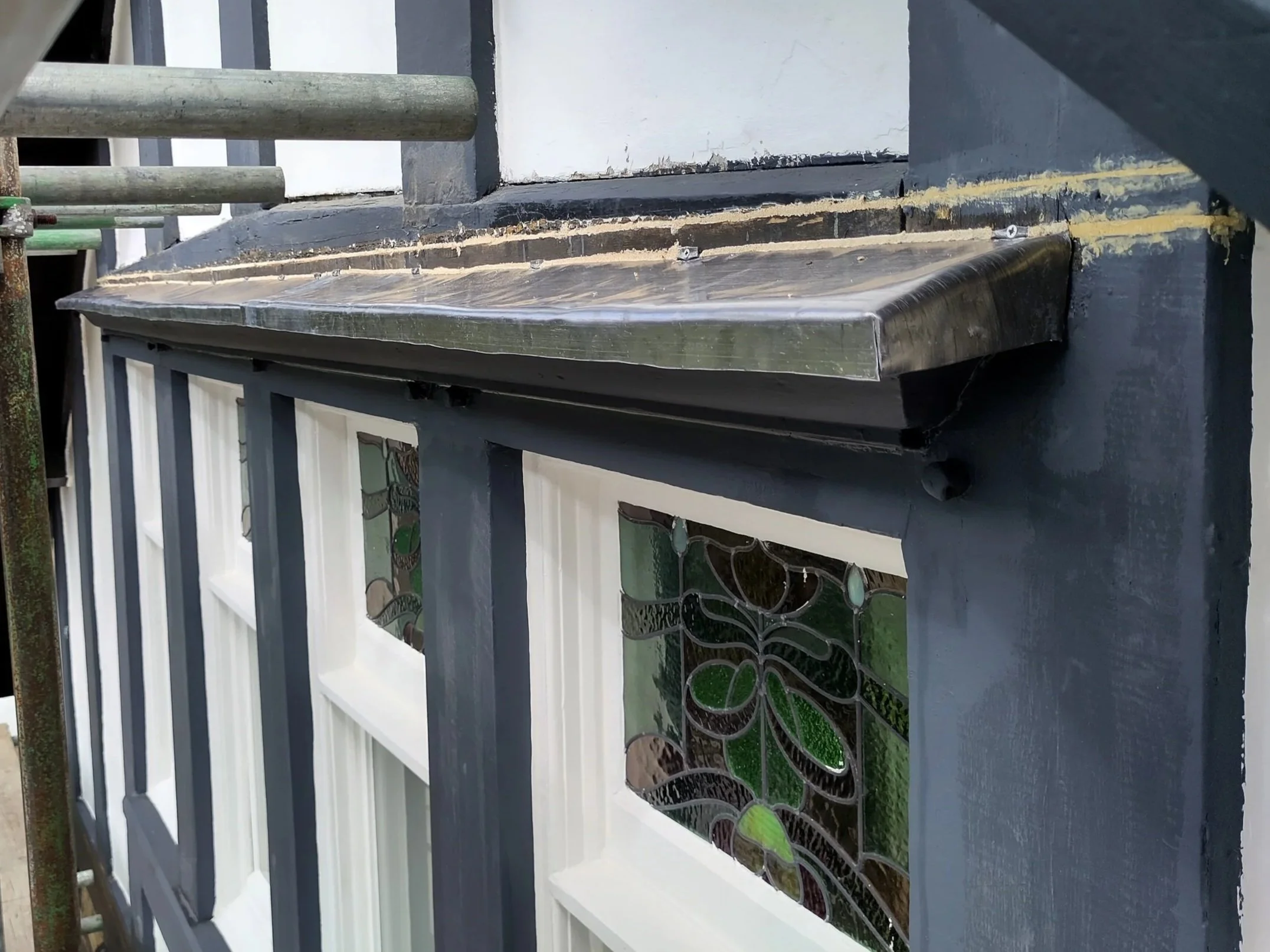 Close‑up of the lead flashband above the window frame, showing its role in weatherproofing.
