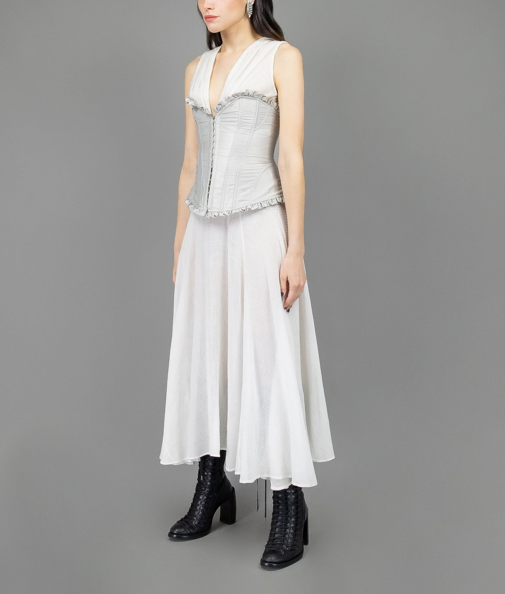 collector of vision model is wearing a size small cottagecore corset by victorias secret showing off the side with box pleated trim, hook and eye front closure, sweetheart neckline
